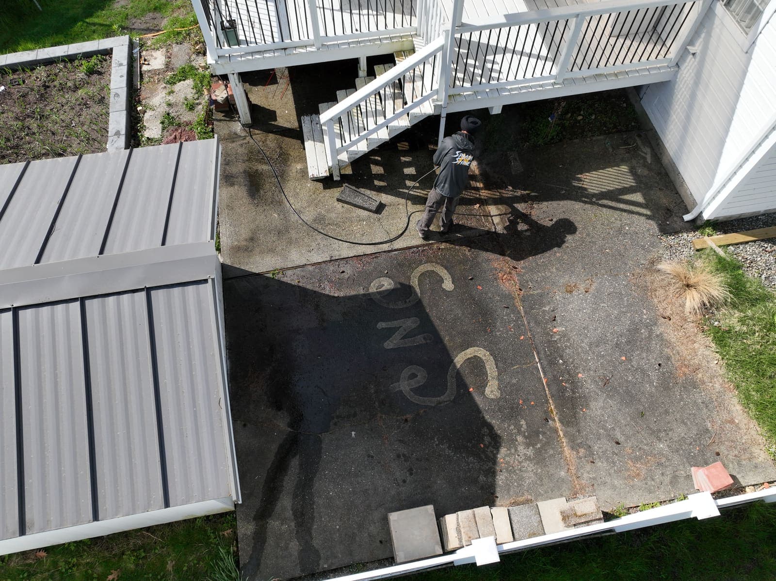 Aerial view of a stained residential driveway before pressure washing