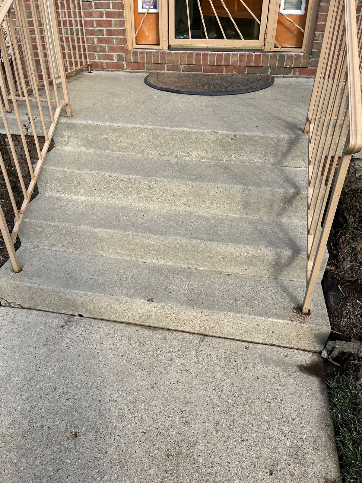 Concrete walkway and steps at a house entrance