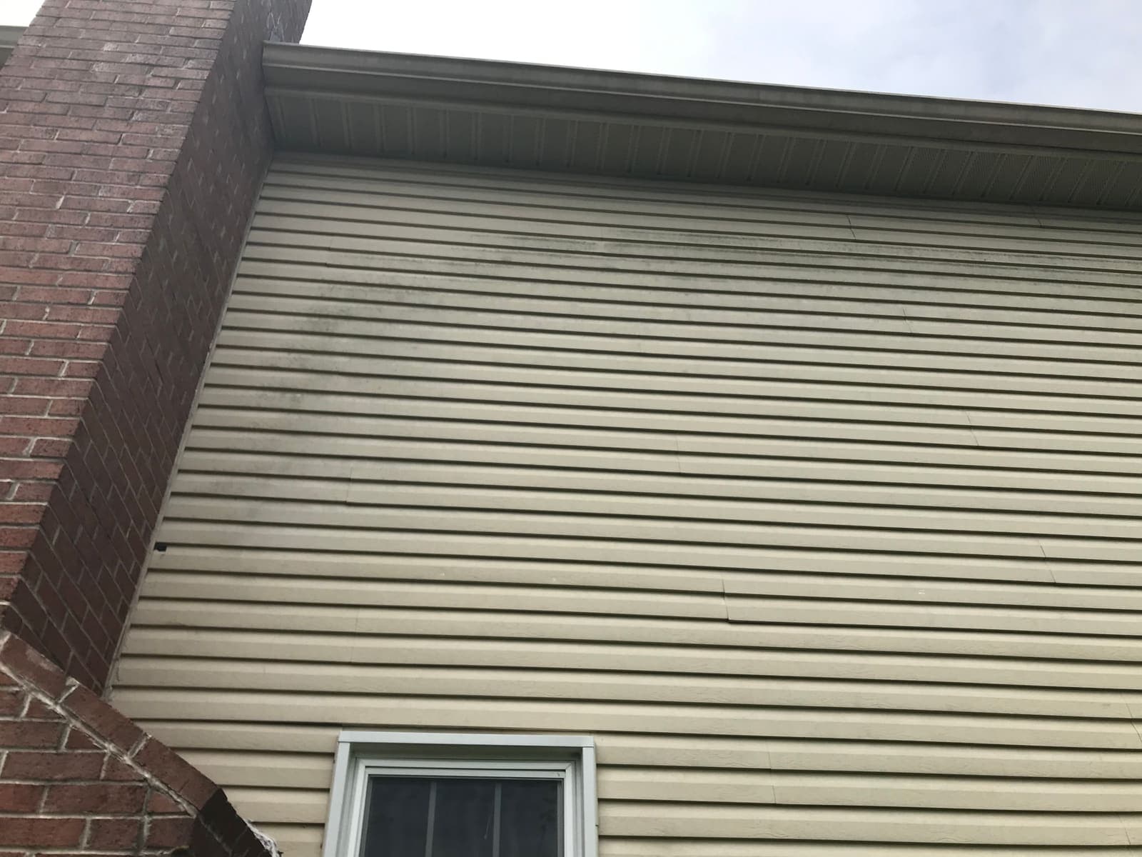 Soiled siding on a gable end before house washing
