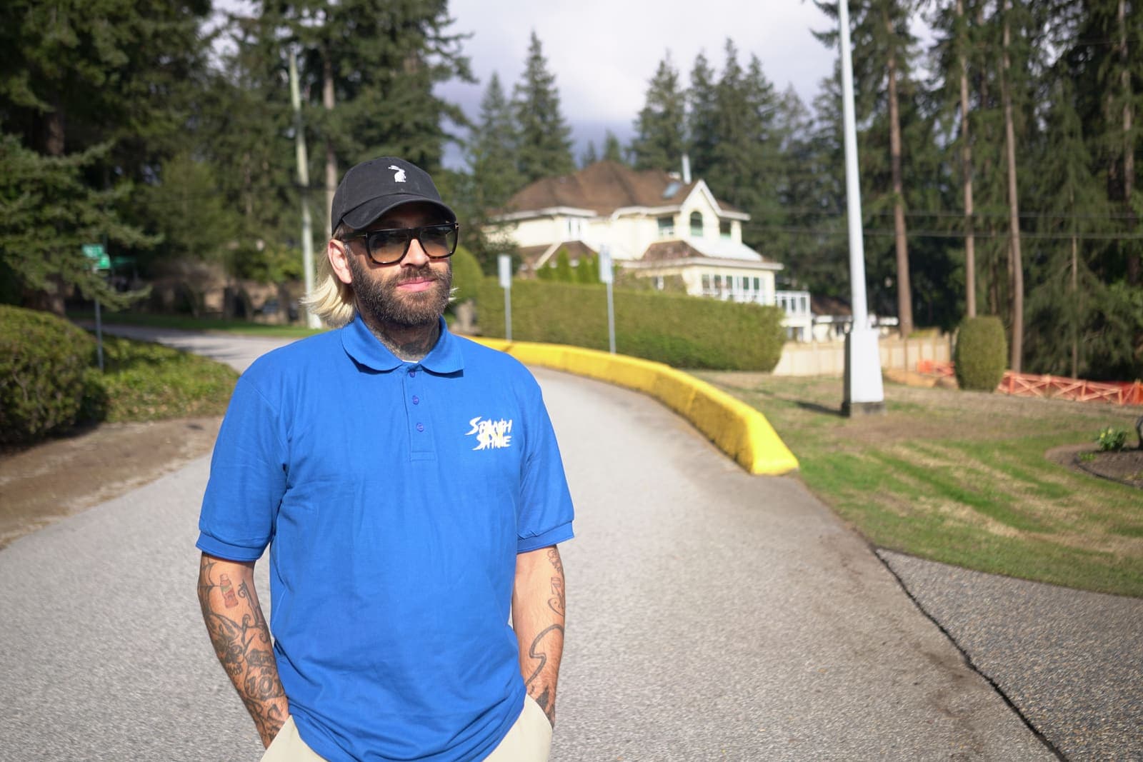 Uniformed exterior cleaning technician on a residential driveway