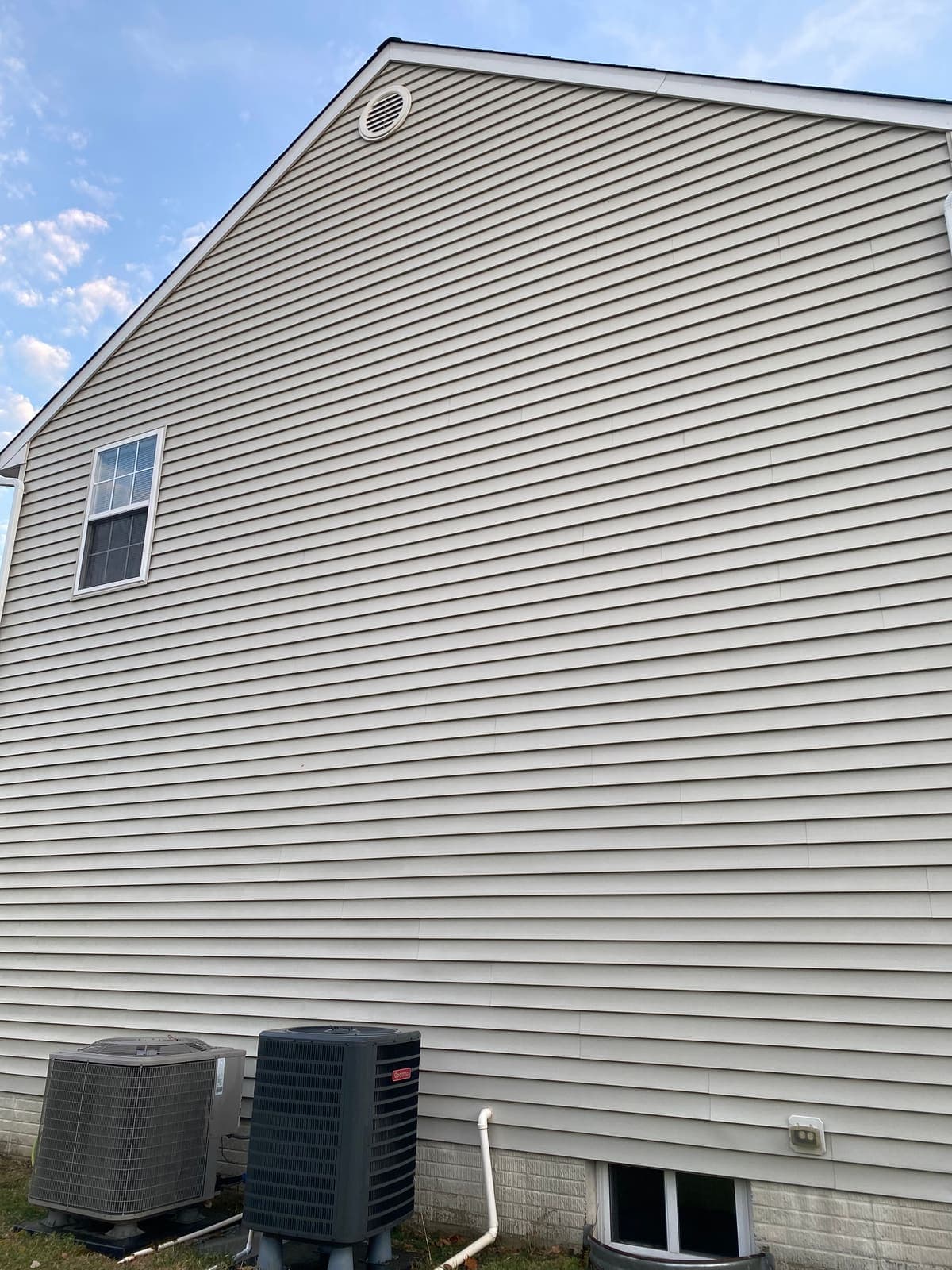Grey siding restored after a house washing