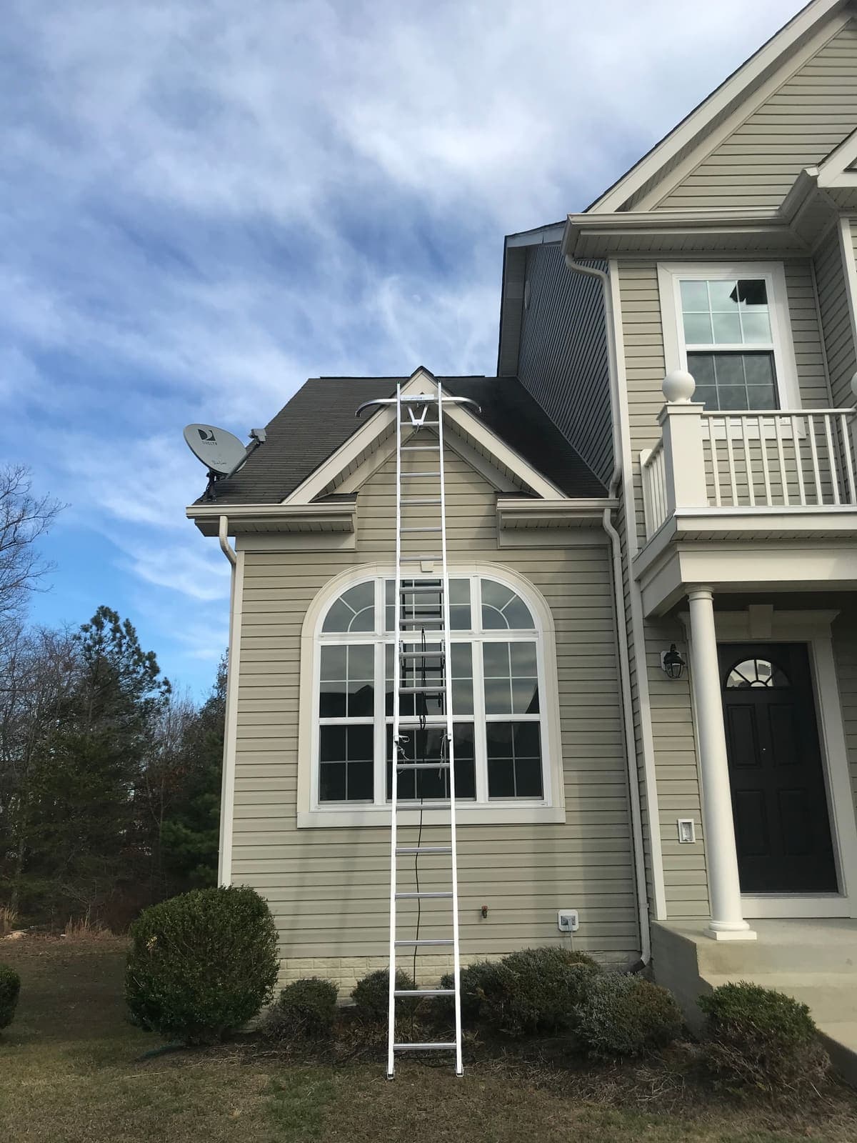 Ladder set against a house for gutter cleaning