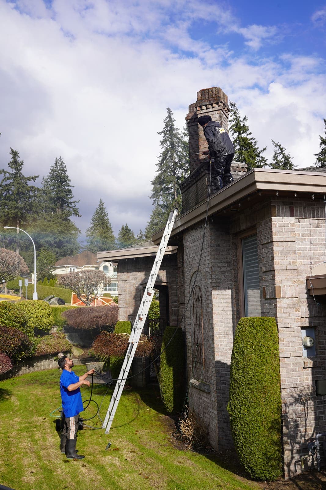 Extension ladder set against a stone house for safe roof access