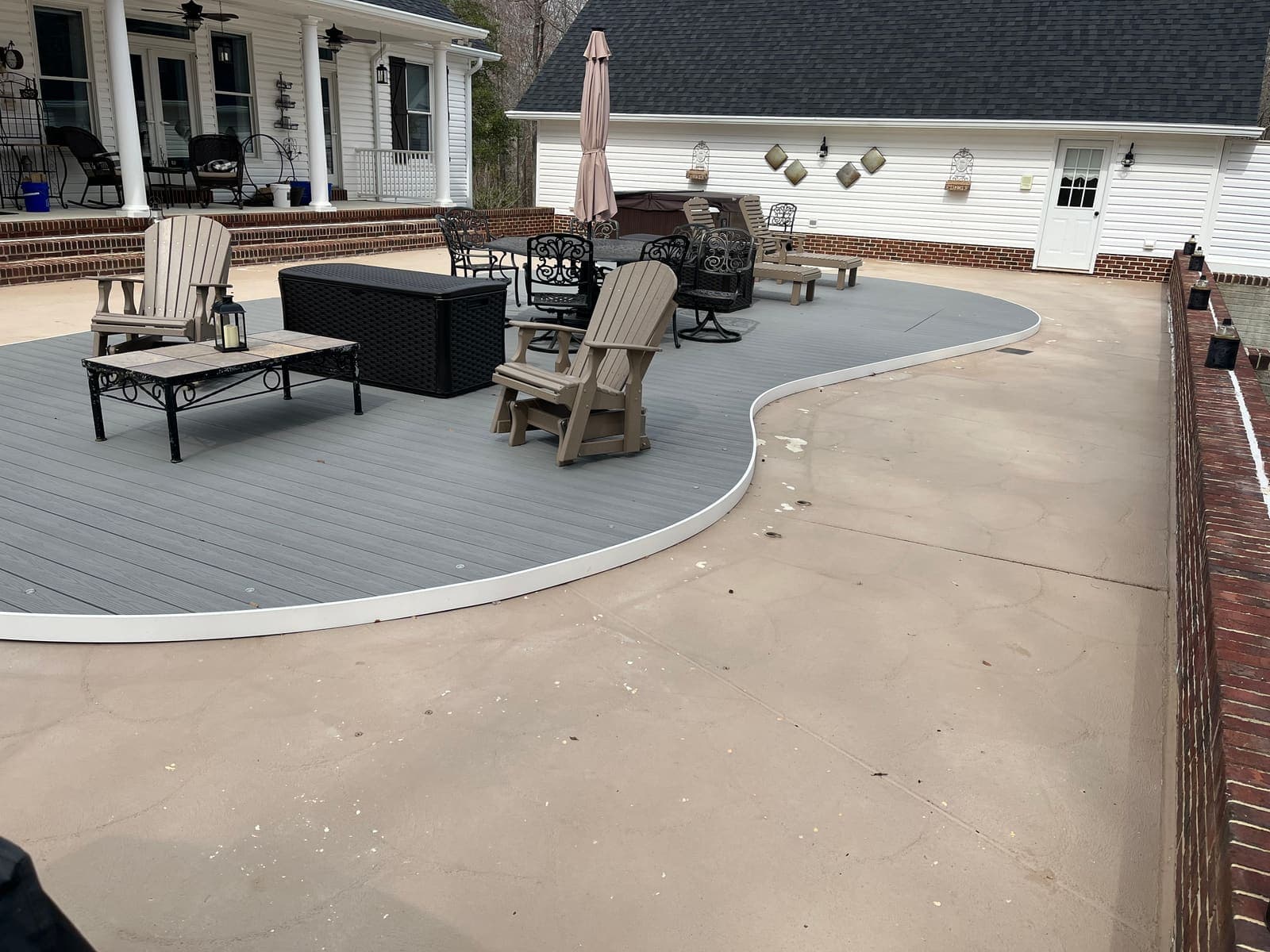 Large concrete pool patio after pressure washing