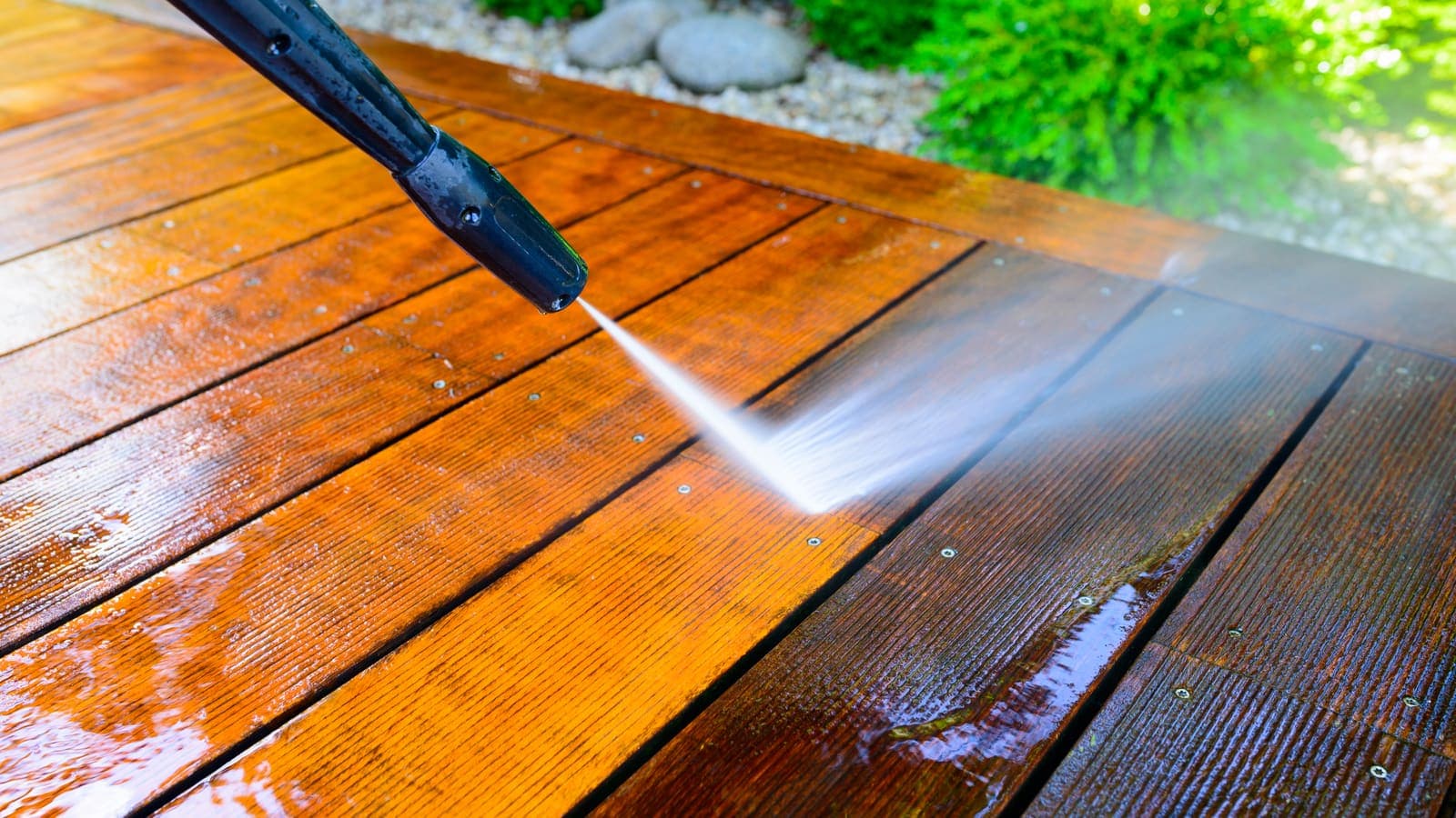 Pressure washing stained deck boards clean