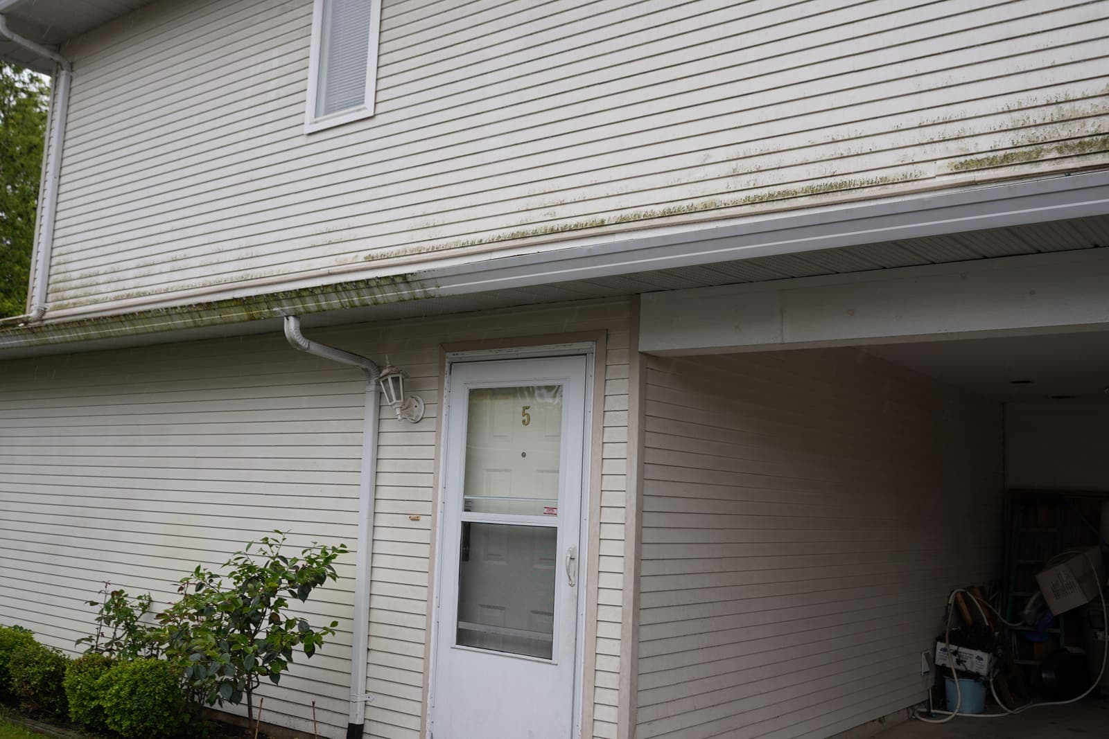 Townhouse carport and siding before pressure washing