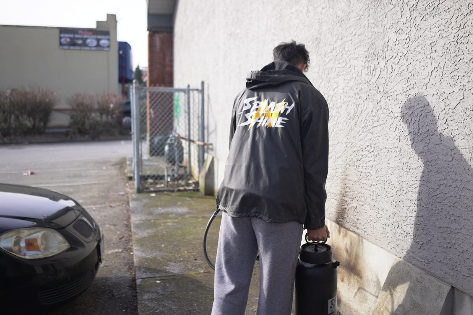 A worker cleaning a commercial building wall