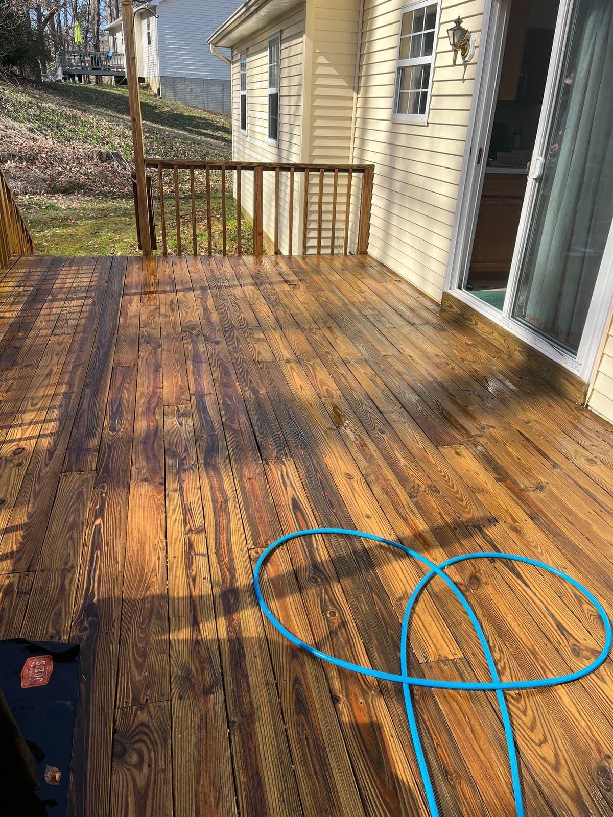 Fully restored wood deck after professional cleaning, boards warm and evenly toned